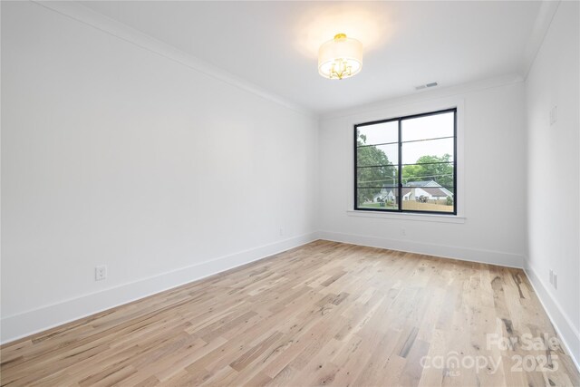 3903 Plainview Rd, Charlotte, NC 28208 - spare room featuring light wood-type flooring, crown molding, and baseboards