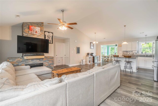 198 Anita Ln, Lexington, NC 27295 - living area with dark wood-style flooring, ceiling fan, plenty of natural light, baseboards, and high vaulted ceiling