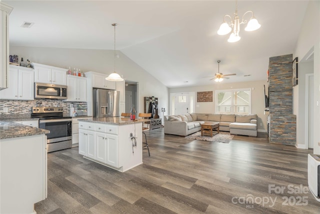 198 Anita Ln, Lexington, NC 27295 - kitchen featuring stainless steel appliances, vaulted ceiling, backsplash, white cabinets, and hanging light fixtures