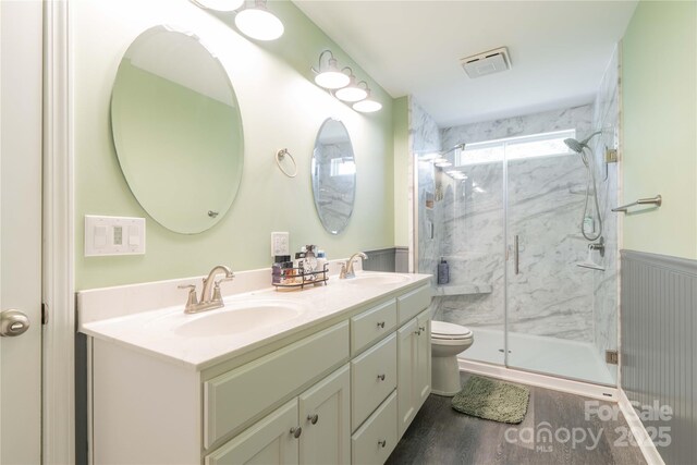 198 Anita Ln, Lexington, NC 27295 - bathroom featuring double vanity, a marble finish shower, wainscoting, wood finished floors, and toilet
