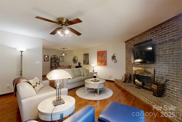4920 Surfwood Dr, Sherrills Ford, NC 28673 - living room featuring wood finished floors, ceiling fan, a brick fireplace, and baseboards