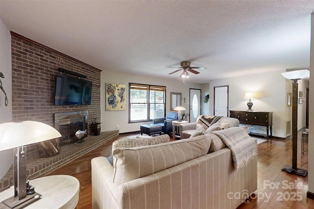 4920 Surfwood Dr, Sherrills Ford, NC 28673 - living area featuring wood finished floors, ceiling fan, baseboards, and a textured ceiling