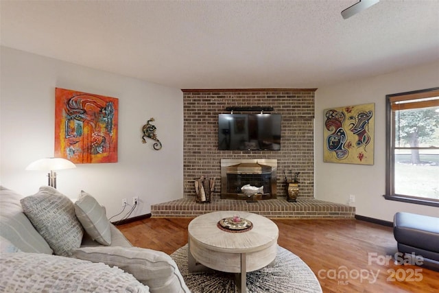 4920 Surfwood Dr, Sherrills Ford, NC 28673 - living room featuring baseboards, wood finished floors, and a brick fireplace