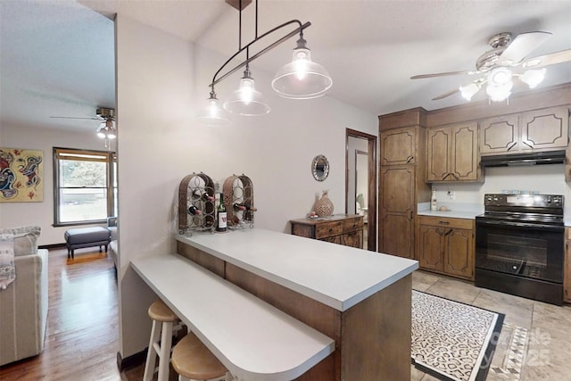 4920 Surfwood Dr, Sherrills Ford, NC 28673 - kitchen featuring black electric range oven, ceiling fan, under cabinet range hood, light countertops, and a peninsula