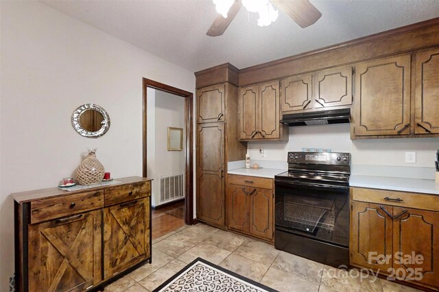 4920 Surfwood Dr, Sherrills Ford, NC 28673 - kitchen with black electric range oven, under cabinet range hood, ceiling fan, and light countertops