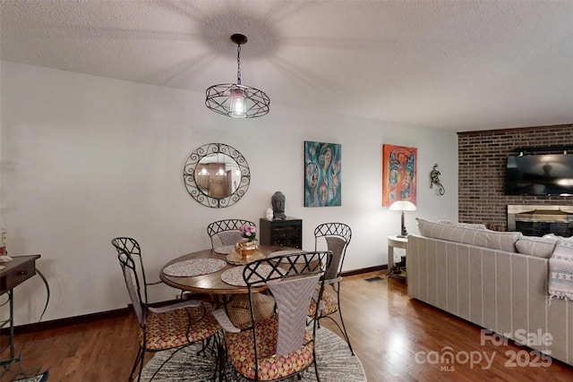 4920 Surfwood Dr, Sherrills Ford, NC 28673 - dining space featuring wood finished floors, baseboards, and a textured ceiling