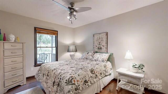 4920 Surfwood Dr, Sherrills Ford, NC 28673 - bedroom with dark wood-style floors, a ceiling fan, and baseboards
