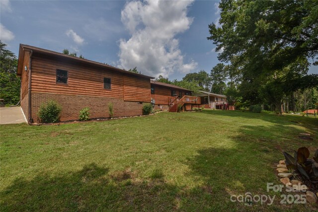 4920 Surfwood Dr, Sherrills Ford, NC 28673 - view of side of property with brick siding, a lawn, a deck, and stairway