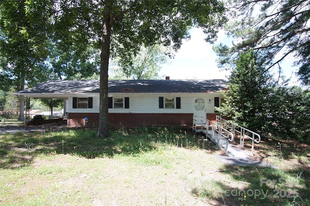 402 Villa St, Kannapolis, NC 28083 - view of front facade featuring brick siding and a carport