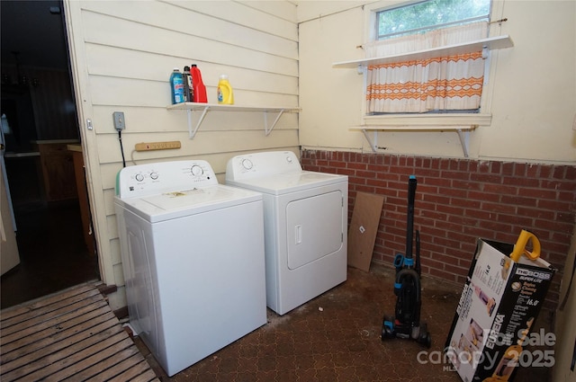 402 Villa St, Kannapolis, NC 28083 - washroom featuring independent washer and dryer, tile patterned floors, and brick wall