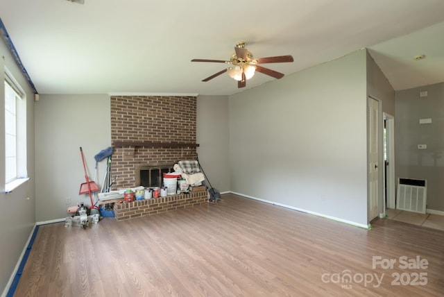 8019 Walnut Creek Ln, Charlotte, NC 28227 - unfurnished living room featuring wood finished floors, a ceiling fan, and a brick fireplace