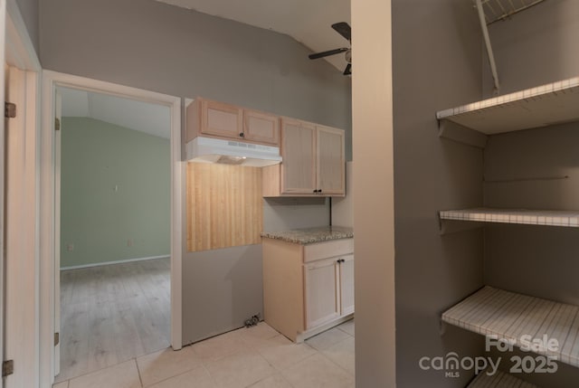 8019 Walnut Creek Ln, Charlotte, NC 28227 - kitchen featuring under cabinet range hood, lofted ceiling, ceiling fan, light countertops, and light brown cabinetry