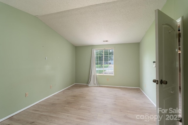 8019 Walnut Creek Ln, Charlotte, NC 28227 - spare room featuring light wood-type flooring and a textured ceiling