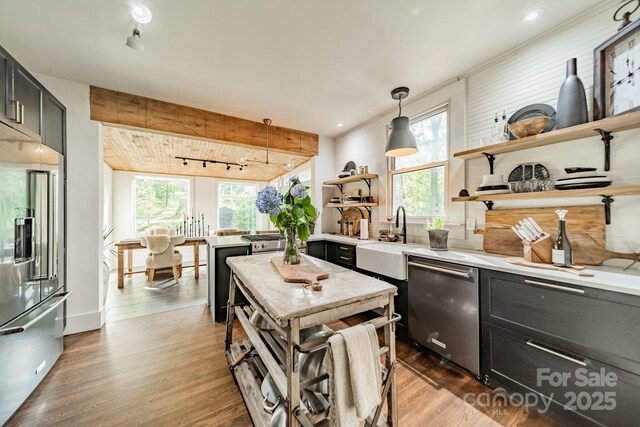 7901 Bud Henderson Rd, Huntersville, NC 28078 - kitchen with stainless steel appliances, rail lighting, open shelves, light countertops, and wood finished floors