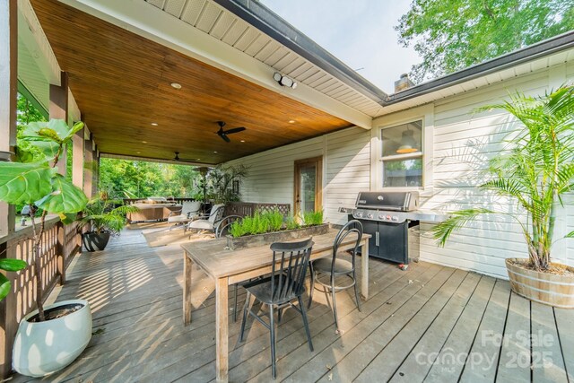 7901 Bud Henderson Rd, Huntersville, NC 28078 - deck with outdoor dining area, a grill, and ceiling fan
