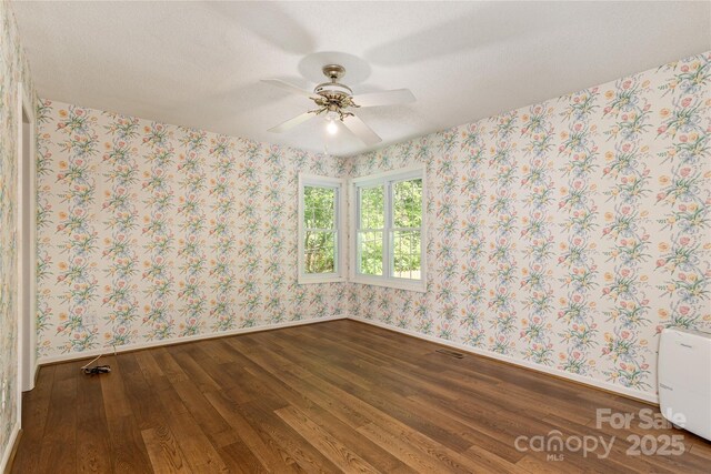 93 Wood Duck Ct, Brevard, NC 28712 - unfurnished room with wood finished floors, wallpapered walls, and ceiling fan