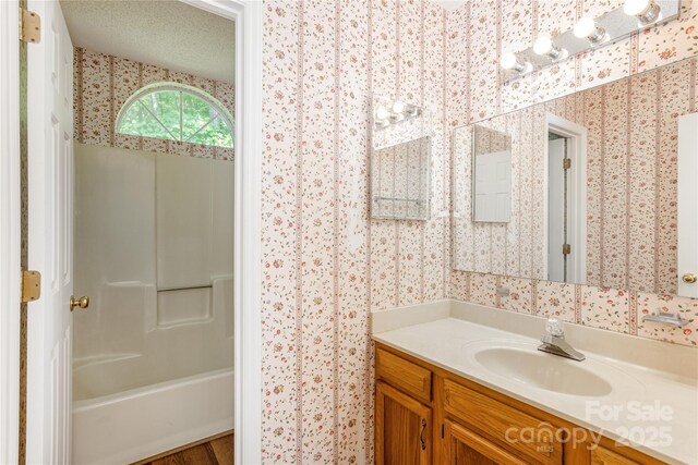 93 Wood Duck Ct, Brevard, NC 28712 - bathroom featuring wallpapered walls, vanity, and bathtub / shower combination