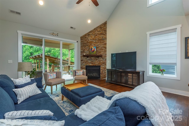 253 Flat Creek Rd, Black Mountain, NC 28711 - living area with high vaulted ceiling, a ceiling fan, wood finished floors, healthy amount of natural light, and a stone fireplace