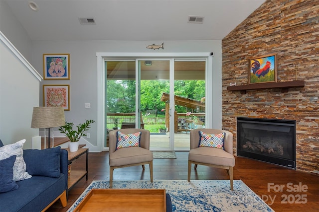 253 Flat Creek Rd, Black Mountain, NC 28711 - living area with lofted ceiling, wood finished floors, a stone fireplace, and baseboards
