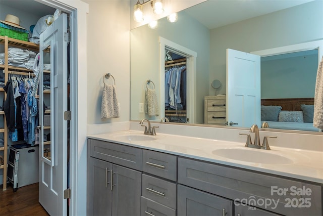 253 Flat Creek Rd, Black Mountain, NC 28711 - full bathroom with double vanity, a spacious closet, and wood finished floors