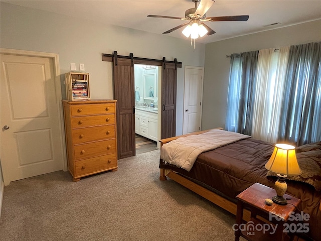 210 Rhyne St, Stanley, NC 28164 - bedroom with a barn door, carpet floors, ensuite bath, and a ceiling fan