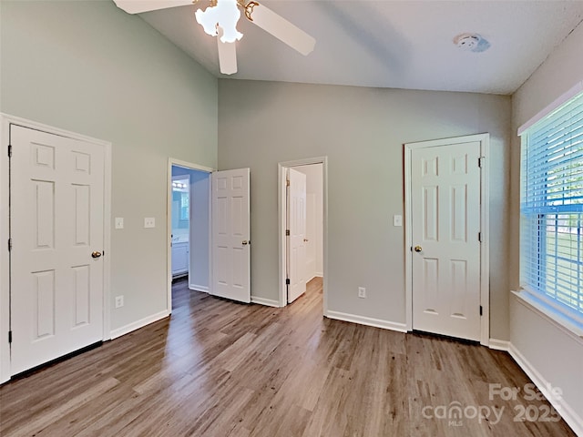 4328 Frank Vance Rd, Charlotte, NC 28216 - unfurnished bedroom featuring wood finished floors, high vaulted ceiling, baseboards, ensuite bath, and a ceiling fan