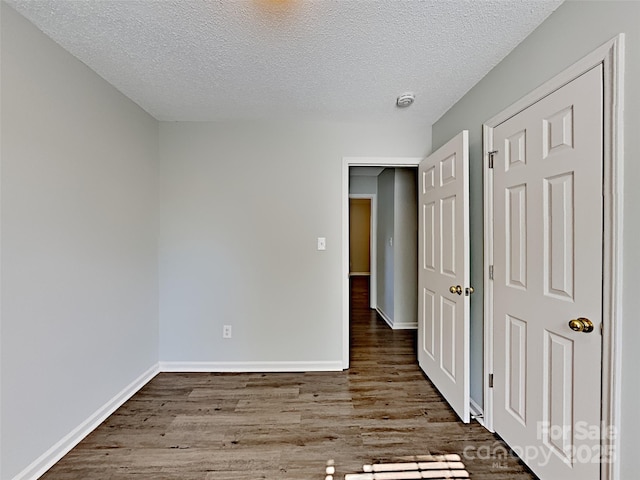 4328 Frank Vance Rd, Charlotte, NC 28216 - unfurnished bedroom featuring wood finished floors, a textured ceiling, and baseboards