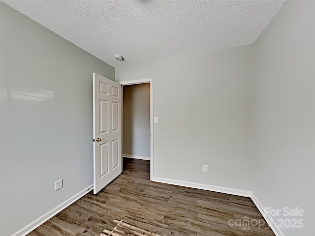 4328 Frank Vance Rd, Charlotte, NC 28216 - spare room with wood finished floors, baseboards, a textured ceiling, and a smoke detector