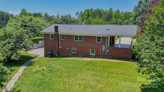 1838 Harmon St, Morganton, NC 28655 - rear view of house featuring a yard, brick siding, and central air condition unit
