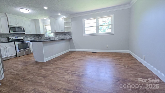 1838 Harmon St, Morganton, NC 28655 - kitchen with appliances with stainless steel finishes, ornamental molding, white cabinetry, open shelves, and backsplash