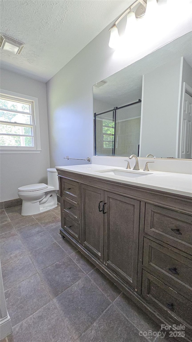 1838 Harmon St, Morganton, NC 28655 - full bathroom featuring toilet, vanity, a shower with shower door, and a textured ceiling