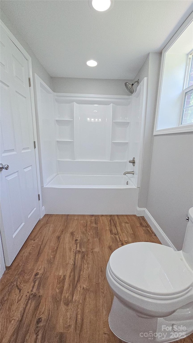 1838 Harmon St, Morganton, NC 28655 - full bath with toilet, wood finished floors, shower / bathtub combination, baseboards, and a textured ceiling