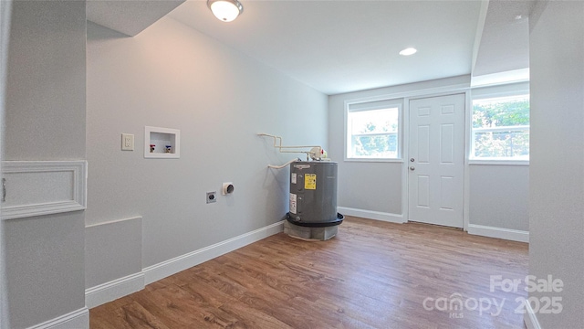 1838 Harmon St, Morganton, NC 28655 - laundry room with washer hookup, electric water heater, electric dryer hookup, wood finished floors, and baseboards