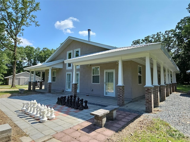 2905 Medlin Rd, Monroe, NC 28112 - back of house featuring stucco siding, a patio, and metal roof