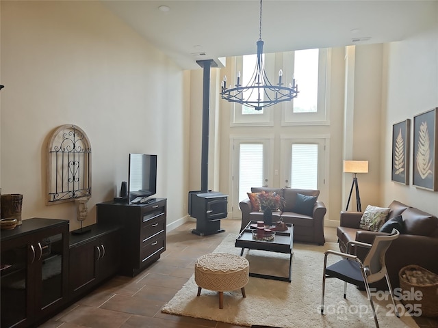 2905 Medlin Rd, Monroe, NC 28112 - living room with a chandelier, a high ceiling, and a wood stove