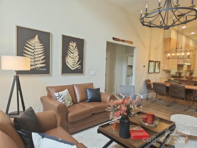 2905 Medlin Rd, Monroe, NC 28112 - living area with a chandelier, wood finished floors, a high ceiling, and baseboards