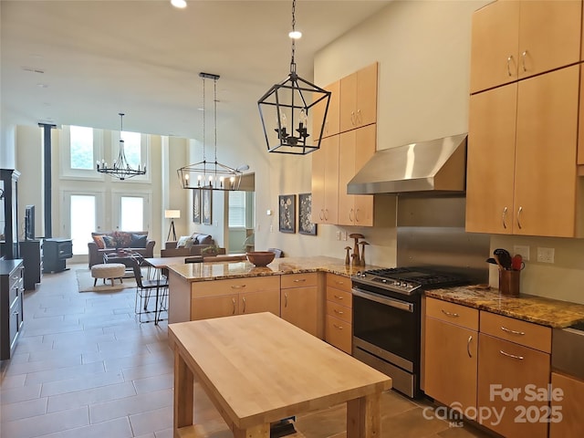 2905 Medlin Rd, Monroe, NC 28112 - kitchen with wall chimney range hood, stainless steel gas range oven, a chandelier, a peninsula, and a high ceiling
