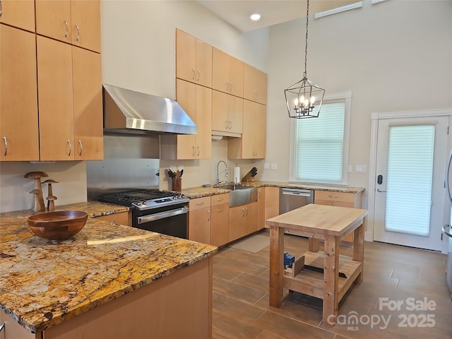 2905 Medlin Rd, Monroe, NC 28112 - kitchen featuring wall chimney range hood, appliances with stainless steel finishes, light stone countertops, pendant lighting, and a chandelier