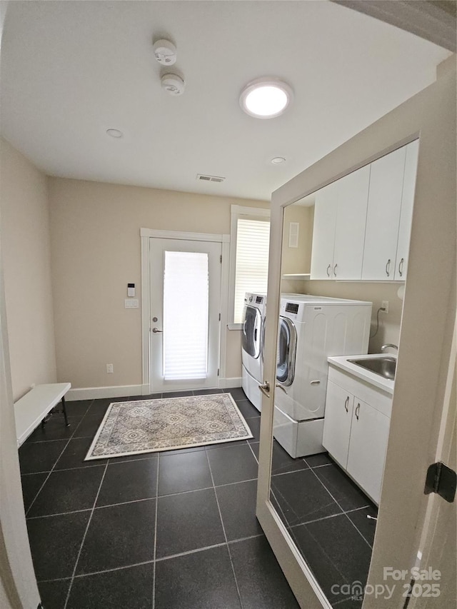 2905 Medlin Rd, Monroe, NC 28112 - washroom featuring washer and dryer, cabinet space, dark tile patterned flooring, and baseboards