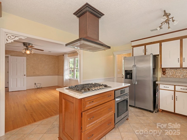 3408 Oak Tree Trl, Matthews, NC 28105 - kitchen featuring appliances with stainless steel finishes, wall chimney range hood, light tile patterned floors, light countertops, and white cabinets