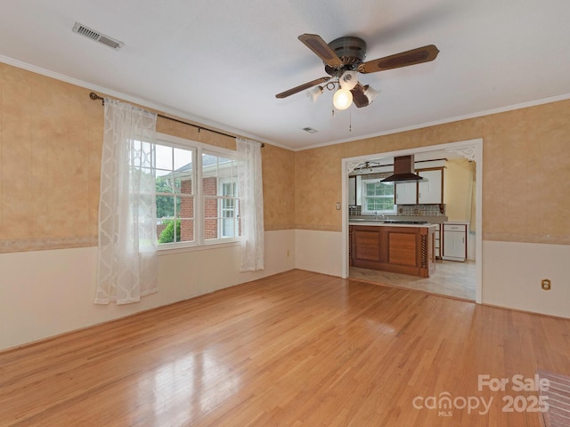 3408 Oak Tree Trl, Matthews, NC 28105 - unfurnished living room with light wood finished floors, a ceiling fan, and ornamental molding
