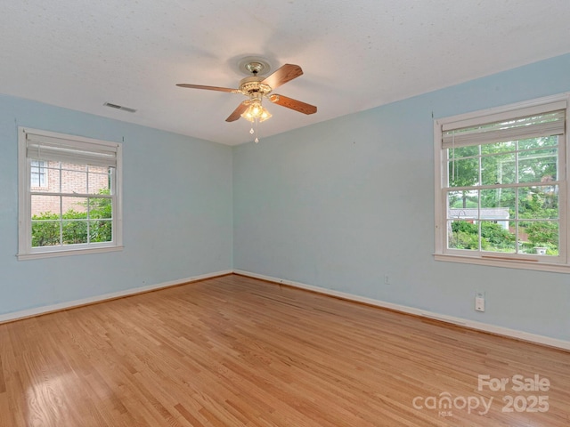 3408 Oak Tree Trl, Matthews, NC 28105 - spare room featuring wood finished floors, baseboards, a ceiling fan, and a textured ceiling