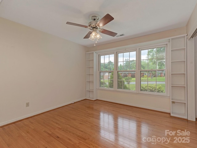 3408 Oak Tree Trl, Matthews, NC 28105 - spare room with baseboards, wood finished floors, and a ceiling fan