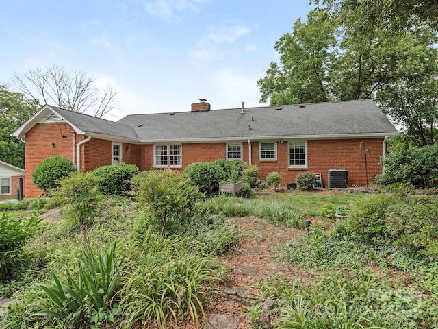 3408 Oak Tree Trl, Matthews, NC 28105 - rear view of house with brick siding, cooling unit, and a chimney