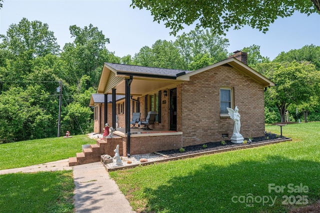 5958 Hoover Elmore Rd, Lincolnton, NC 28092 - view of front of home featuring a porch, a chimney, a front lawn, and brick siding