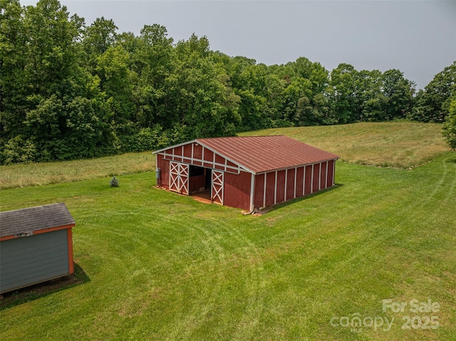 5958 Hoover Elmore Rd, Lincolnton, NC 28092 - view of green lawn with an outdoor structure, an outbuilding, and a view of trees