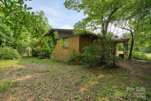 714 Pine St, Hamlet, NC 28345 - view of property exterior featuring brick siding