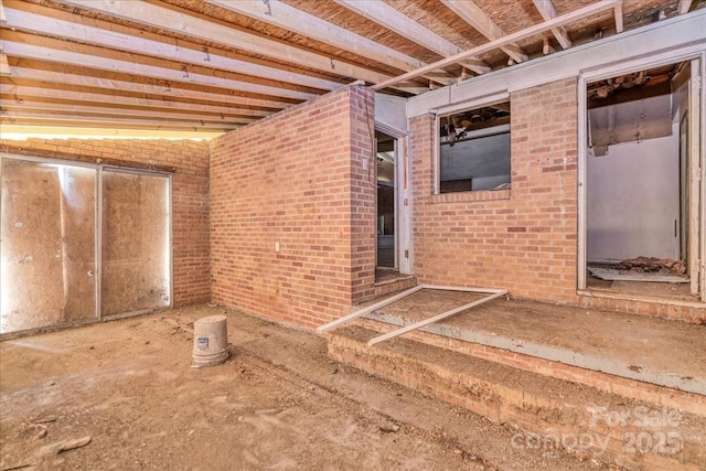 714 Pine St, Hamlet, NC 28345 - miscellaneous room with brick wall