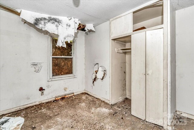 714 Pine St, Hamlet, NC 28345 - unfurnished bedroom with a textured ceiling and a closet