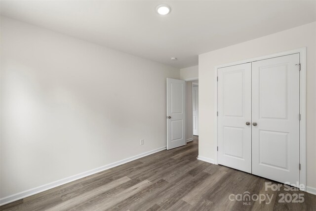 510 3rd St, Salisbury, NC 28144 - unfurnished bedroom featuring dark wood-style flooring, baseboards, and a closet